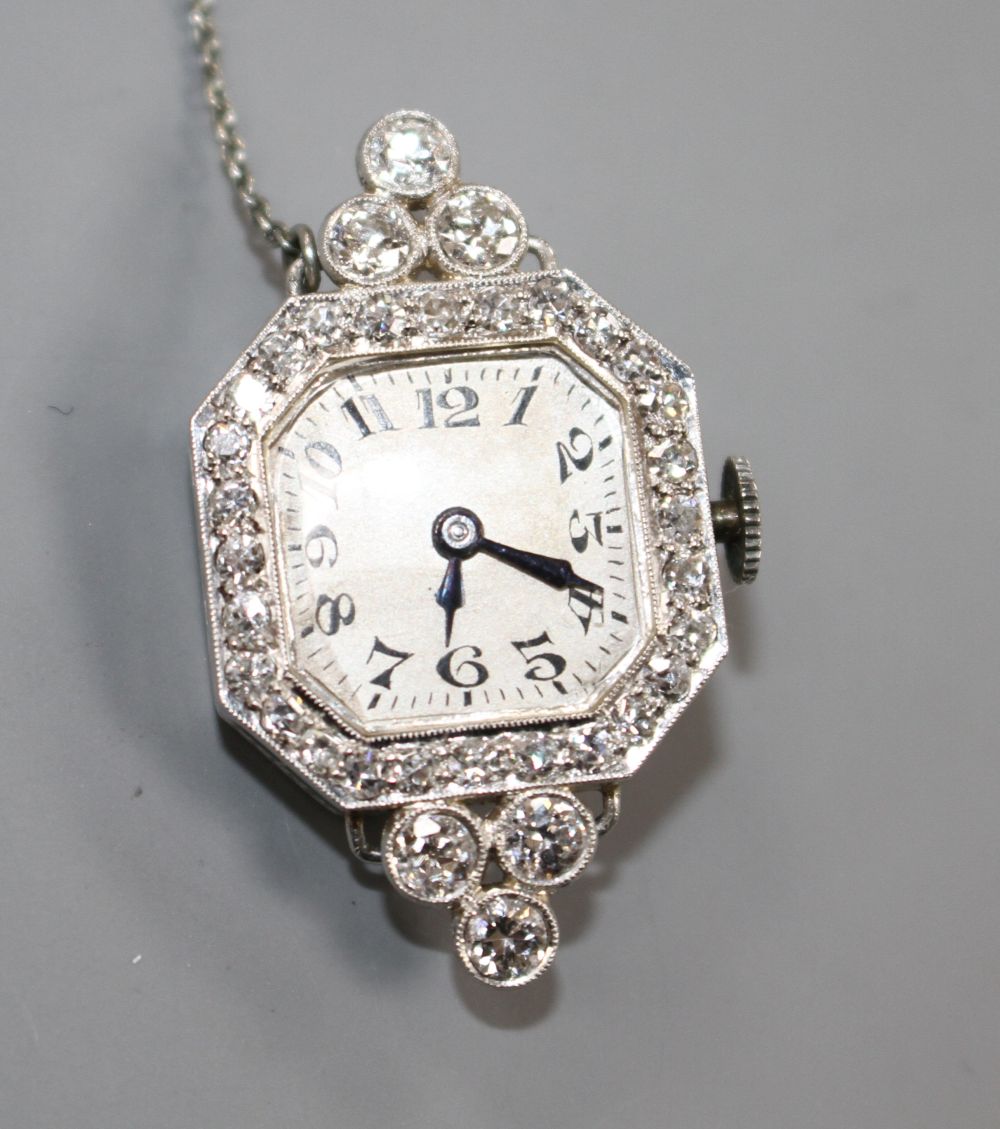 A ladys platinum and diamond set manual wind wrist watch (no strap) now with brooch fitting, 33mm.